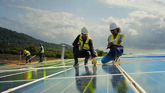 Engineers examining solar panels