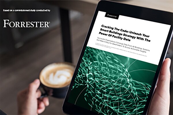 A person holding a tablet displaying a commissioned study by Forrester