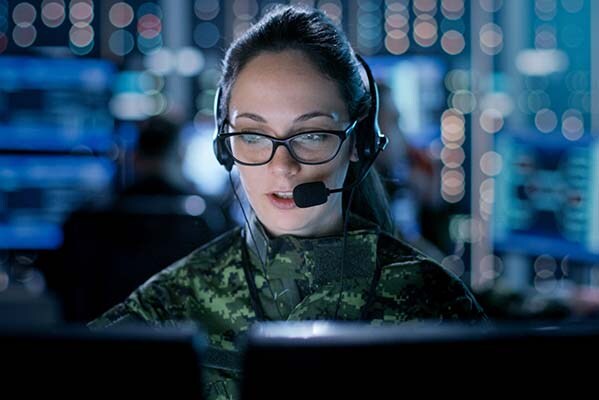 Woman wearing a headset with a microphone working on a computer 