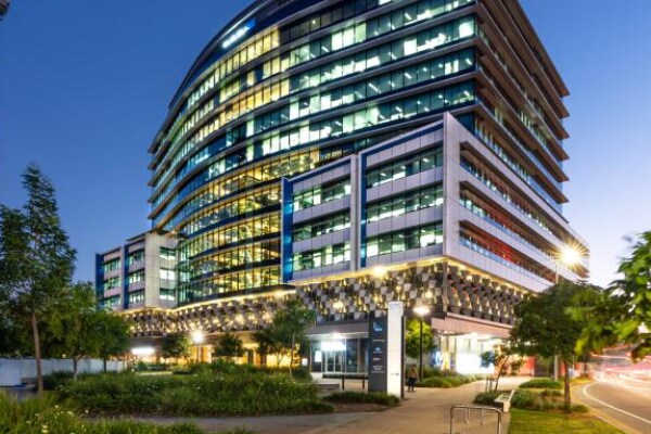 100 Skyring Terrace building lit up at dusk