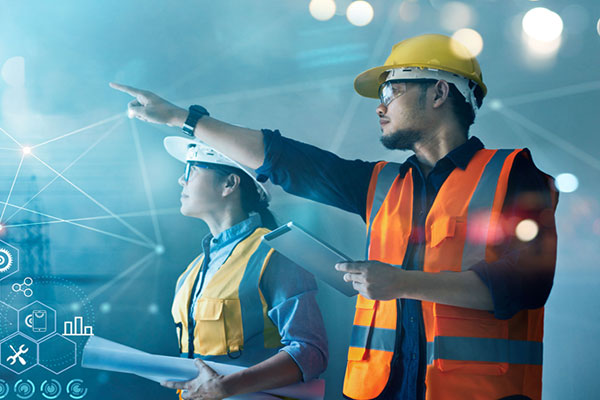 Two people in safety equipment with one pointing at something with graphics imposed on the image