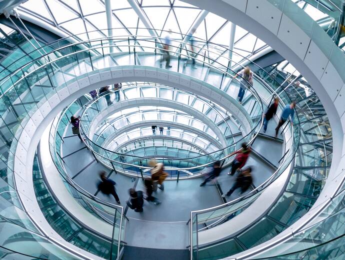 people walking on glass spiral staircase