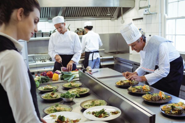 Chefs preparing dishes in the kitchen of a restaurant