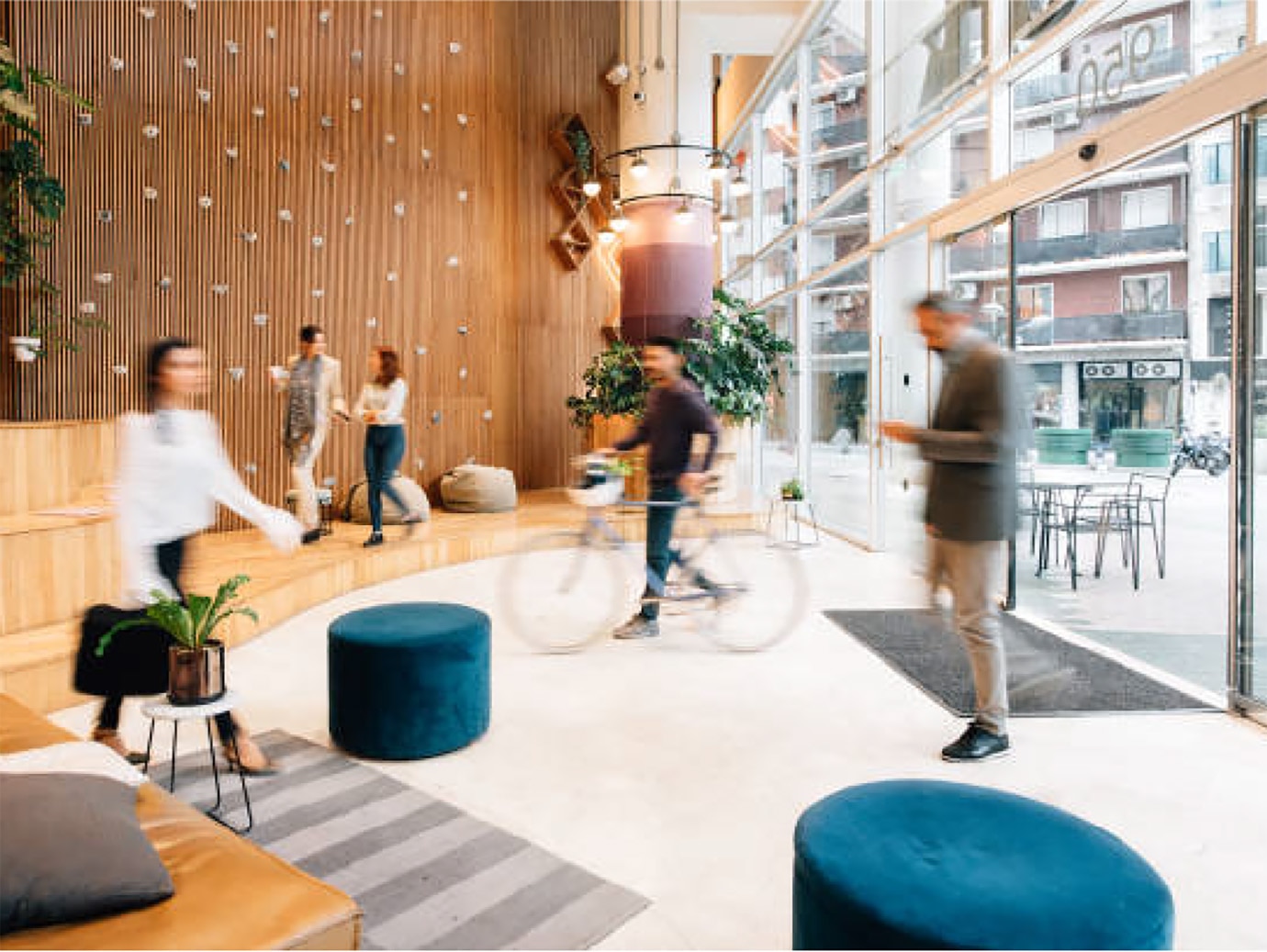 Motion-blur shot of people walking in and out of an office foyer