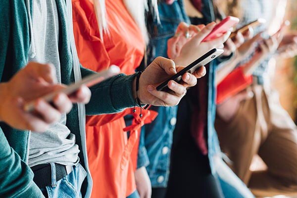 group of people checking mobiles