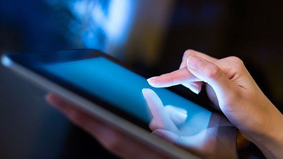 a person finger tapping tablet screen